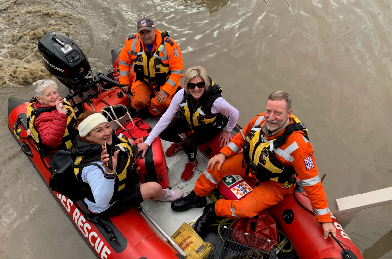 VICSES Port Phillip Unit volunteers in life jackets on a boat, rescue people from floodwaters.